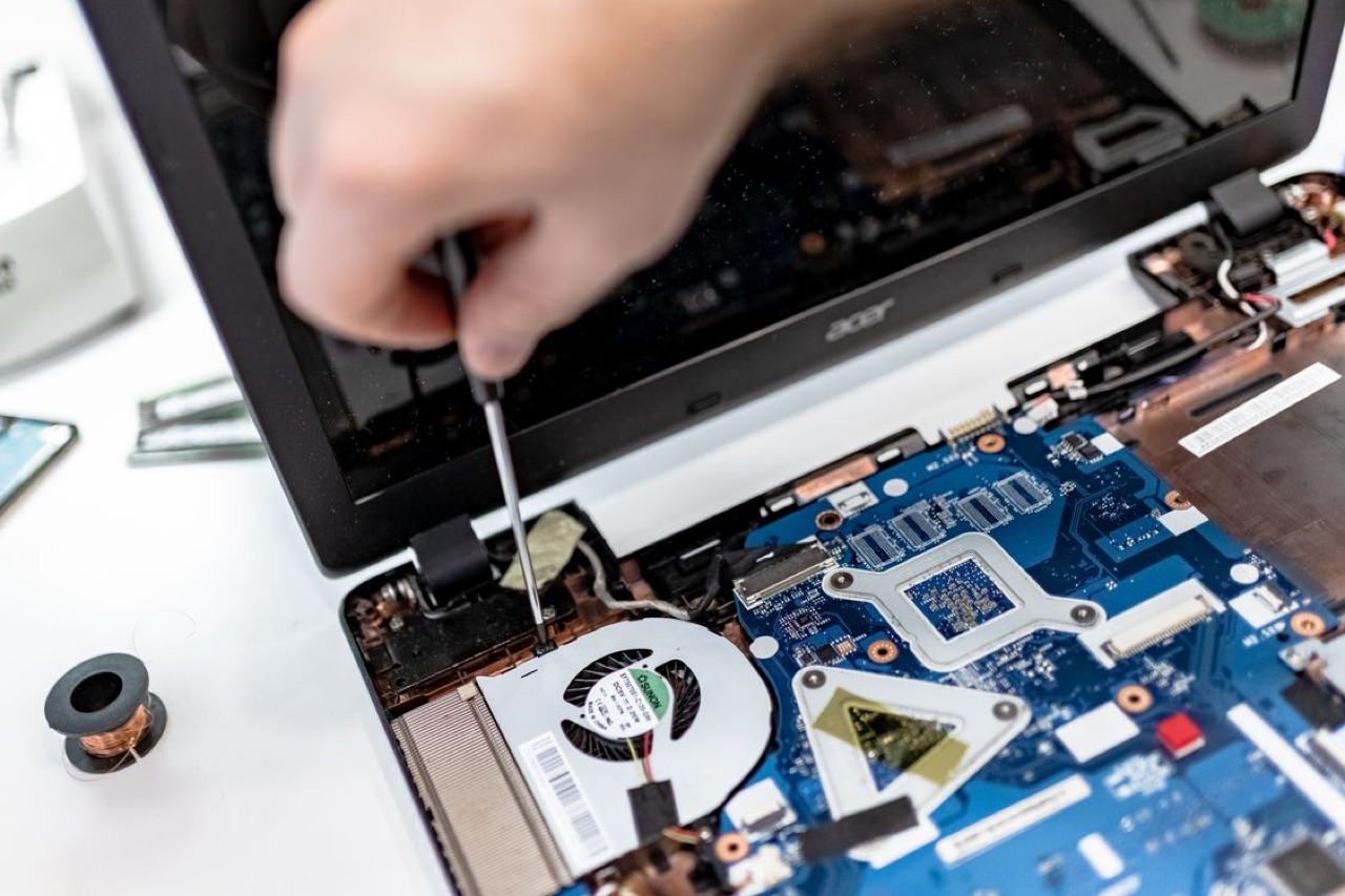 Laptop opened for repair on the bench at Tech Pro Repair in Wilton Manors